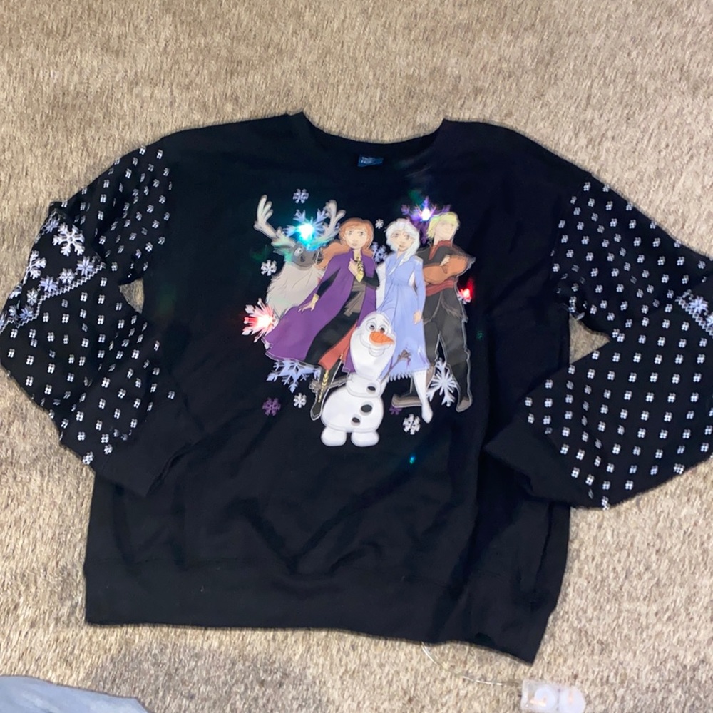 Junior’s size Frozen II crewneck sweatshirt with light up design on front.